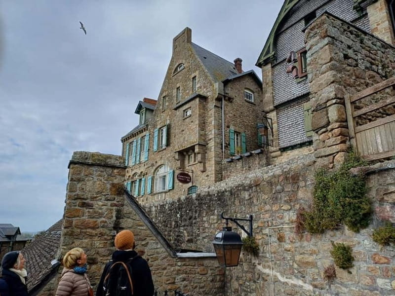 Mont Saint Michel: Village History and Legends Walking Tour - Entering the village through steep medieval lanes