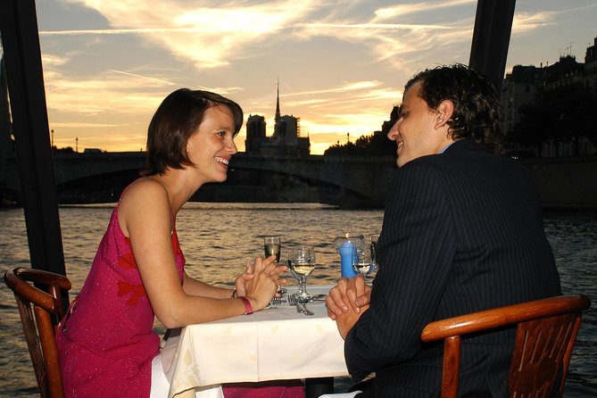 Paris 3-Course Gourmet Dinner and Sightseeing Seine River Cruise - A dinner table with Paris moving past the window