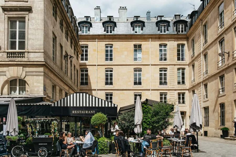 Paris: Emily TV Show Locations Guided Walking Tour - Crossing Pont des Arts for Seine views