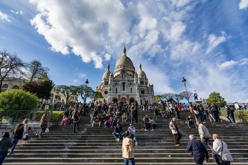 Paris: Montmartre Highlights Walking Tour with a Local Guide - Starting beneath Sacré-Cœur at Place Saint-Pierre